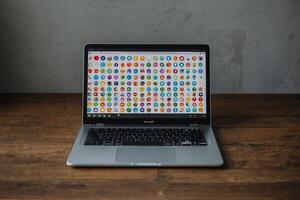 a laptop computer with colorful icons on the screen photo