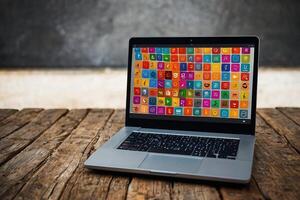 a laptop with colorful icons on the screen photo