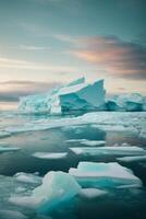 icebergs floating in the water with a sunset photo