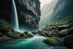 a waterfall in the mountains with a blue sky photo