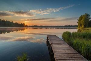 a wooden pier stretches out into the water at sunset photo