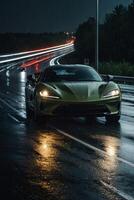 a sports car driving down a wet road at night photo