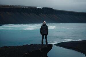 man standing on top of a mountain in iceland photo