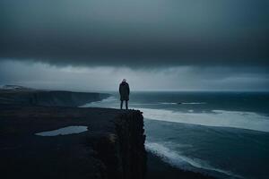 man standing on the edge of a cliff overlooking the Irish landscape photo