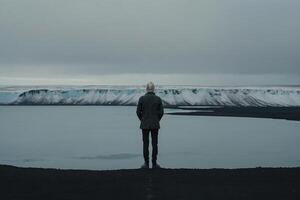 man standing on the edge of a cliff overlooking the Irish landscape photo