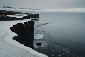 a person standing on the edge of a cliff overlooking the ocean photo