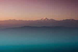 a mountain range with a sunset in the background photo