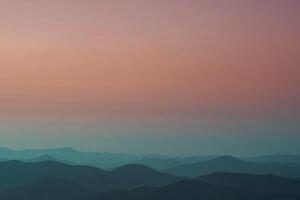 a mountain range with a sunset in the background photo