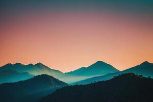 a mountain range with a sunset in the background photo