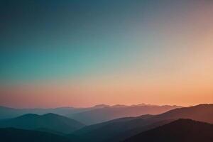 a mountain range with a sunset in the background photo