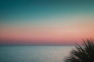 the sun setting over the ocean in a tropical beach photo