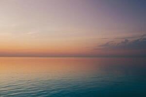 the sun setting over the ocean in a tropical beach photo