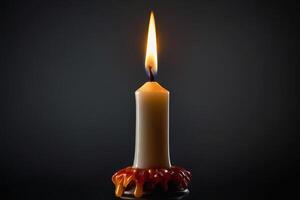 candle with burning candle on black background photo