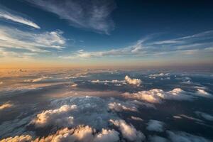 the sun is setting over the clouds as seen from an airplane photo