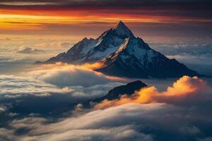 a mountain is seen above the clouds photo