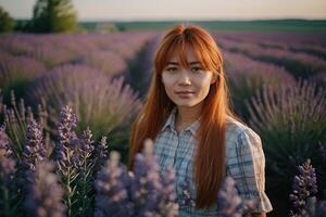 red-haired girl walks through a lavender field photo