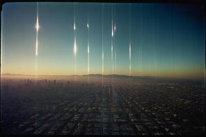 a view of the city from an airplane with the sun setting photo