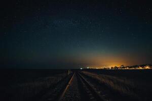 the night sky over a city and mountains photo