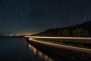 star trails over the ocean at night photo