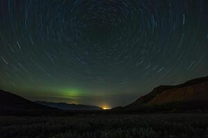 the aurora borealis over the mountains photo