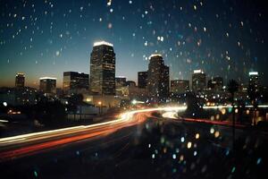 a city skyline at night with lights and rain photo