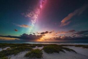 a rainbow over the ocean at night photo