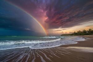 a rainbow over the ocean at night photo