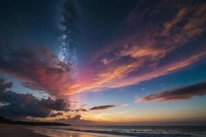 a rainbow is seen over the ocean at night photo