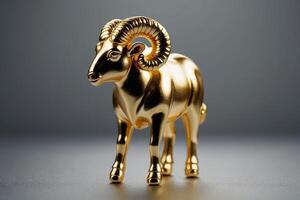 a gold ram head on a gray background photo