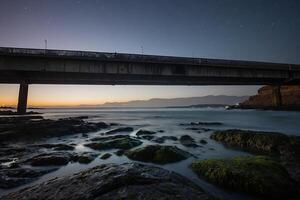 AI generated a bridge over the ocean at night with stars in the sky photo