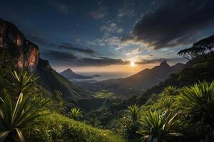 the sun sets over the mountains and vegetation photo