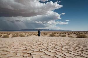 a woman in a black dress walking in the desert photo