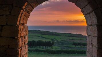 a view of the sea through an archway photo