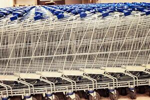 Empty Supermarket Trolley with Blue Handle photo