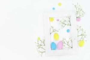 Easter spring composition with color eggs, flowres and frame photo