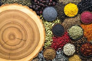 Condiments scattered on table with empty space for text or menu. Colorful spices and herbs background. photo