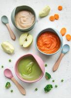 Healthy baby food in bowls photo