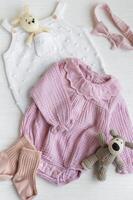 Set of pink clothes and accessories for newborn baby. photo