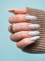 Female hands with blue nail design. Blue nail polish manicure. photo