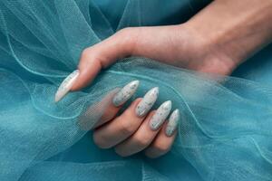 Female hands with blue nail design. Blue nail polish manicure. photo