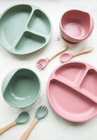 Collection of reusable colorful plastic dishes and bowls photo
