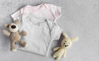 Baby bodysuits  on a grey background. photo