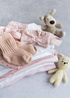 Stack of Baby bodysuits on a grey background. photo