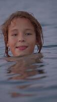 Boy splashing to the camera in slowmo video