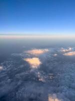 Cumulus clouds in sunbeams on a blue horizon. Top view photo