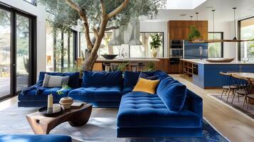 Stunning modern open-plan living and kitchen area with luxurious blue velvet sofa,wooden accents,and natural light photo