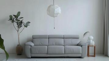 Minimalist Living Room featuring Gray Leather Sofa and Geometric Pendant Light photo