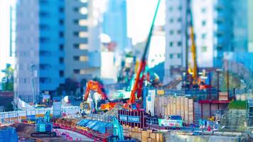 A timelapse of moving miniature cranes at the under construction tiltshift video