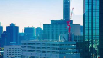 A timelapse of moving cranes at top of the building in Tokyo long shot video