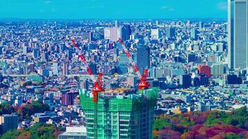 A timelapse of moving cranes at top of the building in Tokyo high angle long shot video